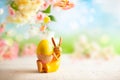 Easter decoration with bunny Easter eggs and beautiful spring flowers on a blurred light background. Easter concept with copy Royalty Free Stock Photo