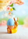 Easter decoration with bunny, Easter eggs and beautiful spring flowers on a blurred light background. Easter concept with copy Royalty Free Stock Photo