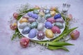 Easter decoration with colored eggs, rabbits, tulips and gypsophila close-up on a light background.