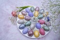 Easter decoration with colored eggs, tulip and gypsophila close-up on a light background.