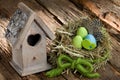 Easter decoration with colourful eggs and small birdhouse