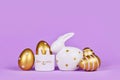 Easter decoration with easter bunny, golden eggs and egg cup Royalty Free Stock Photo