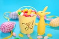Easter decoration with egg shaped candies in bucket and rabbit f Royalty Free Stock Photo