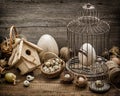 Easter decoration with eggs, birdhouse and birdcage Royalty Free Stock Photo