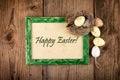 Easter decoration with green wooden frame. Top view Text Happy Easter