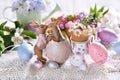 Easter decoration with kissing bunnies figurine and spring flowers in egg shells