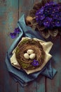 Easter decoration - a nest with wooden eggs and violet flowers