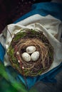 Easter decoration - a nest with wooden eggs - on wooden t