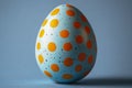Easter decoration: polka dot painted easter egg on blue background for spring design Royalty Free Stock Photo
