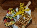 Easter decoration with rabbits and plates with tasty cake and fruit