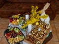 Easter decoration with rabbits and plates with tasty cake and fruit