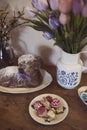 Easter decoration on table with Easter Lamb Sponge Cake and easter gingerbread, tulips and willow yew Royalty Free Stock Photo