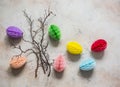 Easter decoration - tree branches, paper colored eggs on a light background, top view. Handmade concept