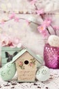 Easter decoration with vintage style bird feeder and eggs