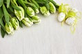 Easter decoration and white tulips on white tablecloth. Copy space