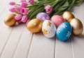 Easter decorations, colorfully painted and decorated Easter eggs and spring flowers on a wood background Royalty Free Stock Photo