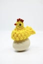 Crochet chick standing near an real egg