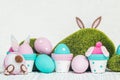 Easter decorations, flowerpots and handmade Easter eggs in pastel colors