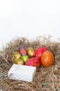 Easter decorative chocolate and chicken eggs in the nest with white gift box Royalty Free Stock Photo