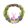 Easter decorative wreath decorated with crocus flowers, branches with young foliage, colorful eggs and a bunny.