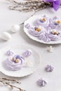 Easter dessert Mini Pavlova Birds Nests with colorful eggs candy on a light background. Meringue Cookies. Festive Food recipe. Royalty Free Stock Photo