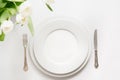 Easter dinner. Table setting with white tulip on white table Royalty Free Stock Photo