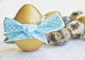 Easter. Easter eggs of gold and natural color on a light background