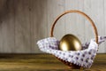 Easter egg in the basket. Wooden background, place for your text