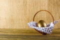 Easter egg in the basket. Wooden background, place for your text