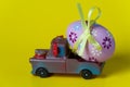 Easter egg on the car a yellow background Royalty Free Stock Photo