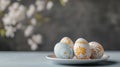 easter egg decorations, colorful hand-painted easter eggs on a white plate in a cheerful kitchen with spring blossoms Royalty Free Stock Photo