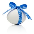 Easter egg with festive blue bow isolated