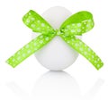 Easter egg with festive green bow isolated on white background