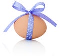 Easter egg with festive purple bow on white background