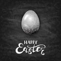 Easter egg with ornate elements on black chalkboard background Royalty Free Stock Photo