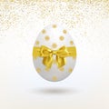 Easter Egg with a Golden Bow and a Falling Golden Confetti