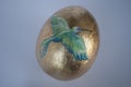 Easter egg hand made. Golden egg with the bird painted