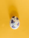 Easter egg handmade painted with modern design in yellow background