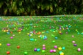 An Easter egg hunt with plastic eggs on a green lawn Royalty Free Stock Photo