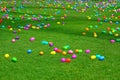 An Easter egg hunt with plastic eggs on a green lawn
