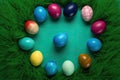 Easter egg hunt concept. Top view photo of various colorful easter eggs hidden among green grass