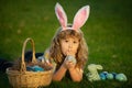 Easter egg hunt in garden. Child boy playing in field, hunting easter eggs. Child bunny boy with rabbit bunny ears. Royalty Free Stock Photo