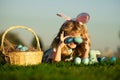 Easter egg hunt in garden. Children playing in field, hunting easter eggs. Cute bunny child boy with rabbit ears, on sky Royalty Free Stock Photo