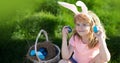 Easter egg hunt. Happy Easter for children. Boy in bunny ears with colorful eggs play and hunting easter eggs outside Royalty Free Stock Photo