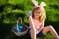 Easter egg hunt. Happy Easter. Kids in bunny ears with Easter egg in basket. Boy play in hunting eggs. Royalty Free Stock Photo