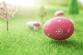 Easter egg hunt with pink colored egg in Dreamland or fairy world