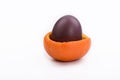 Easter egg in mandarin crust on white background Royalty Free Stock Photo
