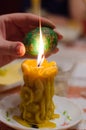 Easter egg in the master's hands above candle Royalty Free Stock Photo