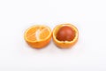 Easter lihgt brown egg in one of the halves of an orange Royalty Free Stock Photo