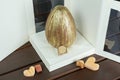 Easter egg ovo de Pascoa decorated with edible golden paint, with double shell stuffed with dulce de leche. On a white box next